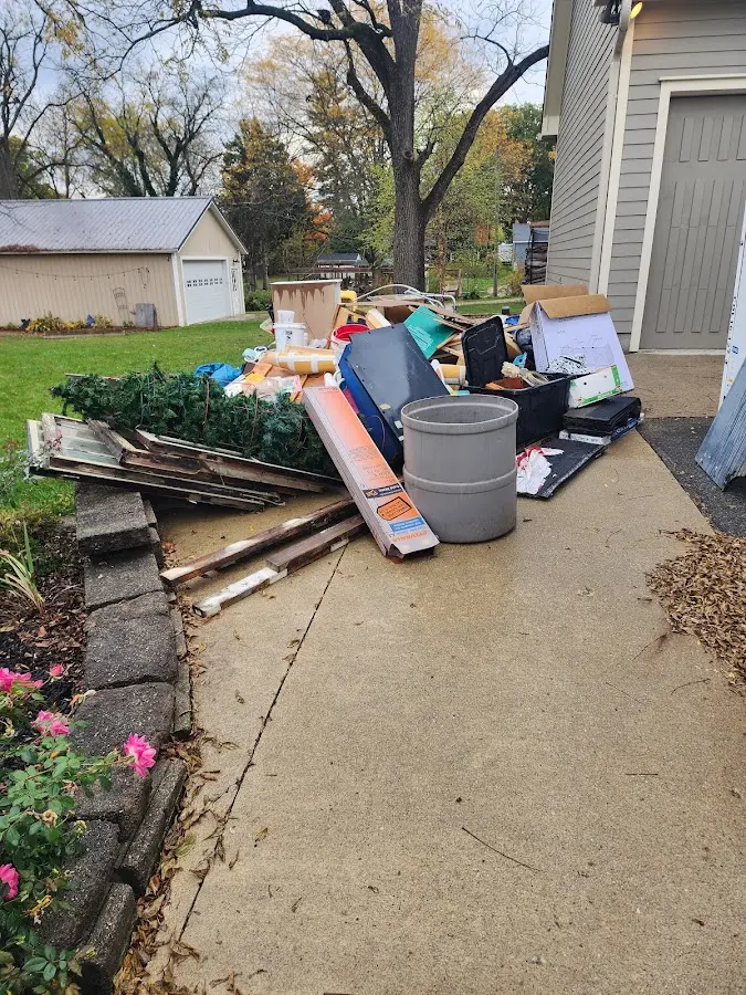 Dumpster being loaded with debris for 12 Yard Dumpster Rental in Kensington